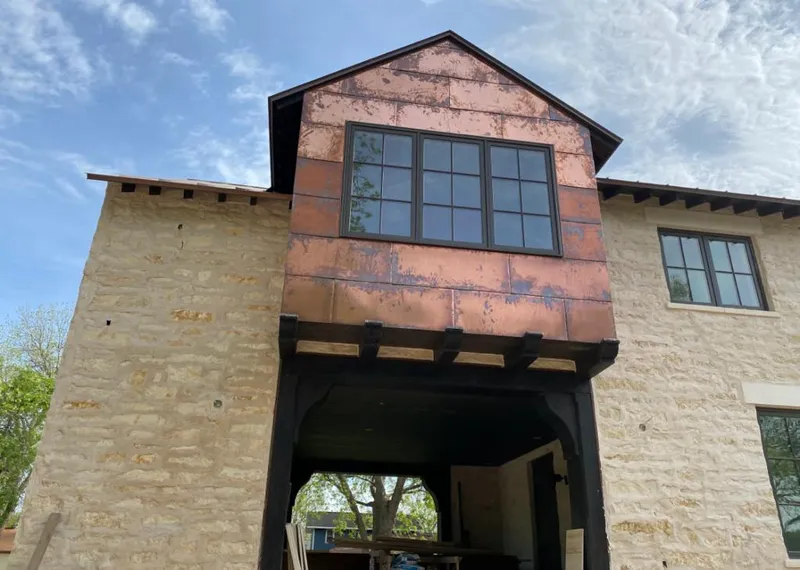 Copper metal panel facade on a stone building for Skylight Installation in Escalon