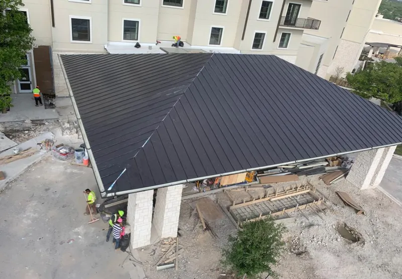 Metal roofing installation team working on a commercial building in Escalon